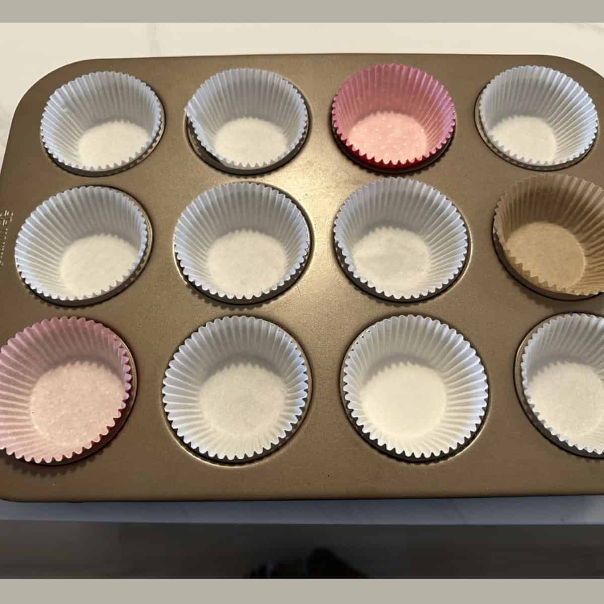 Muffin tray lined with paper cups.