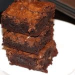 Easy fudgy Brownies stacked on a white plate.