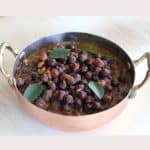 Black gram lentils curry in a copper container .
