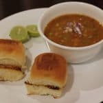 Mumbai Pav Bhaji served in a white plate and bowl.