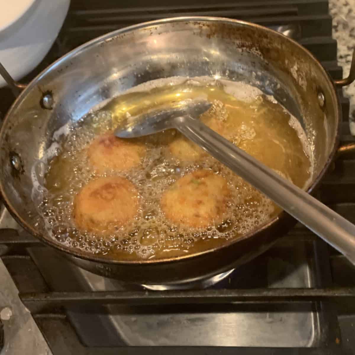 Fish cutlets being deep fried.