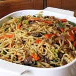 Noodles made with Vegetable hakka noodles recipe served in a white bowl.
