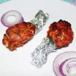 Tandoori chicken oven baked packed with aluminum foil.