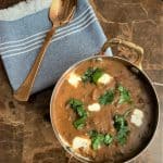 Dal Makhani with the Best Dal makhani recipe served in a brass bowl and brass spoon on the side.