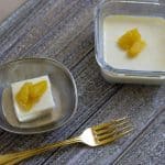 Easy Pineapple pudding served in small container with a gold plated fork.