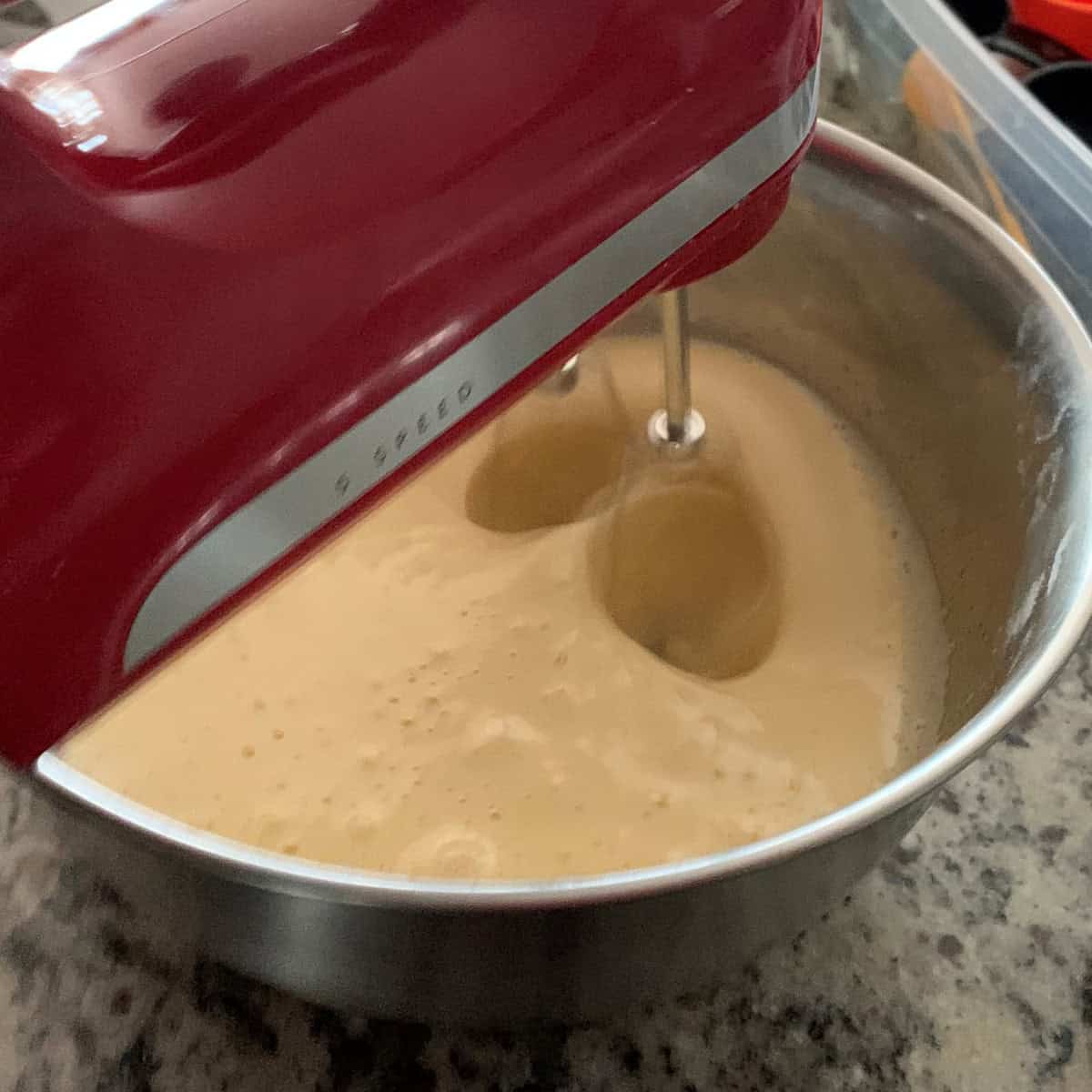 Beating cake batter using a stand mixer.