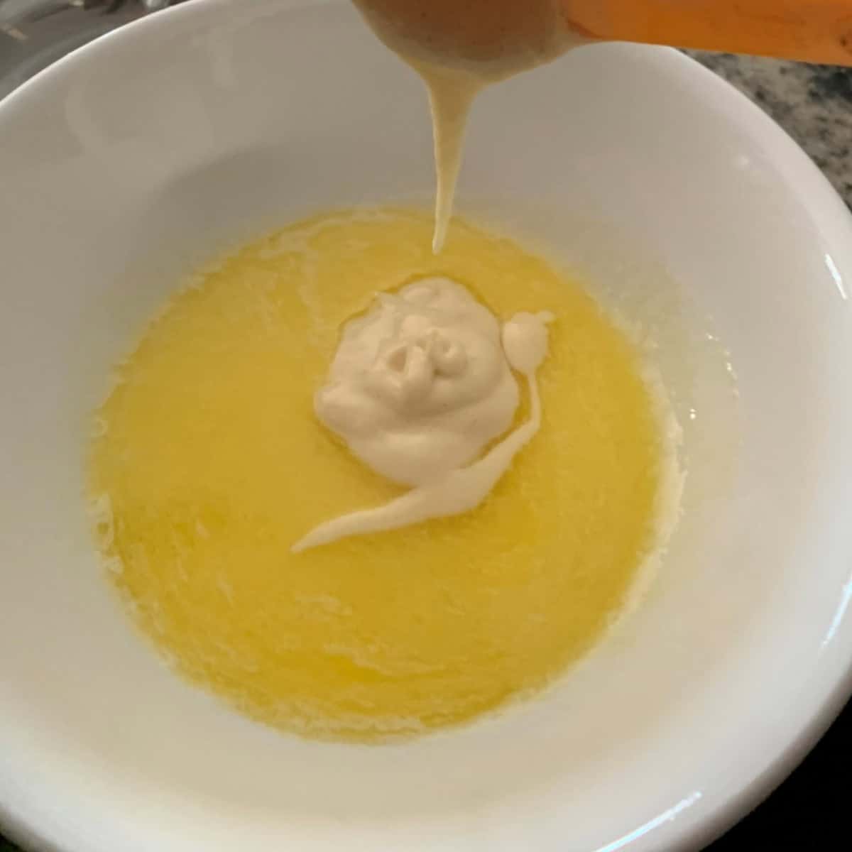 Add batter to butter milk mixture in a white bowl.