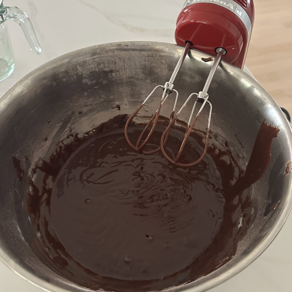 eggless chocolate cake batter in a steel bowl ready to bake.