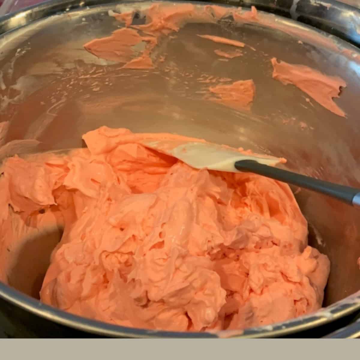whipped cream frosting in a steel bowl.
