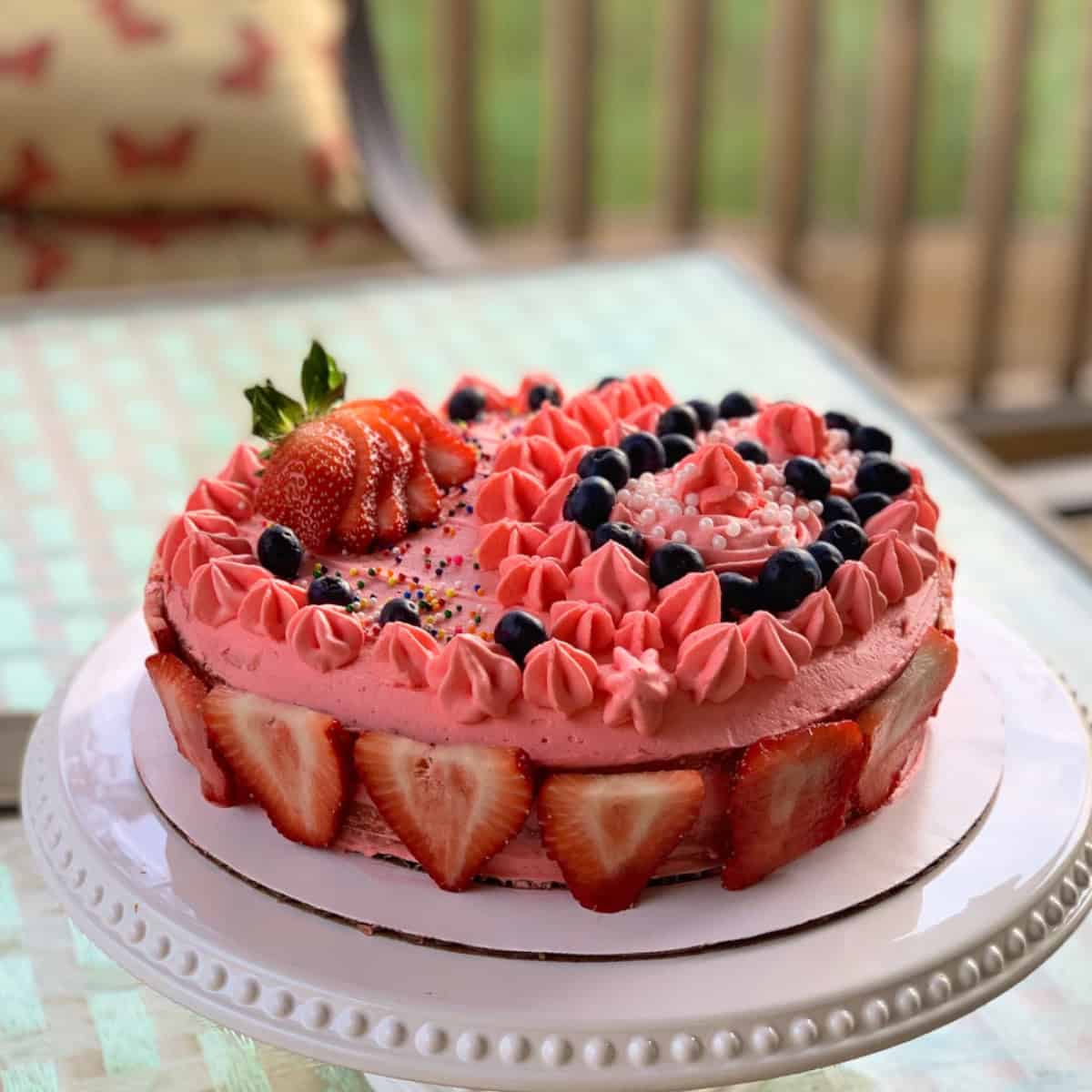 Strawberry shortcake with whipped cream frosting ready.