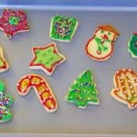 Cut out sugar cookie frosted with Christmas theme and colors.