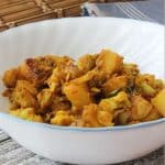 cauliflower and potato dish in a white bowl.
