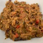 A plate of food with mashed eggplant.