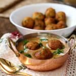 Malai kofta made with easy malai kofta recipe served in a brass container with a golden spoon.