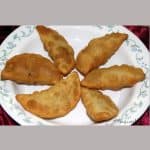 Karanji made with Karanji recipe in a white plate.