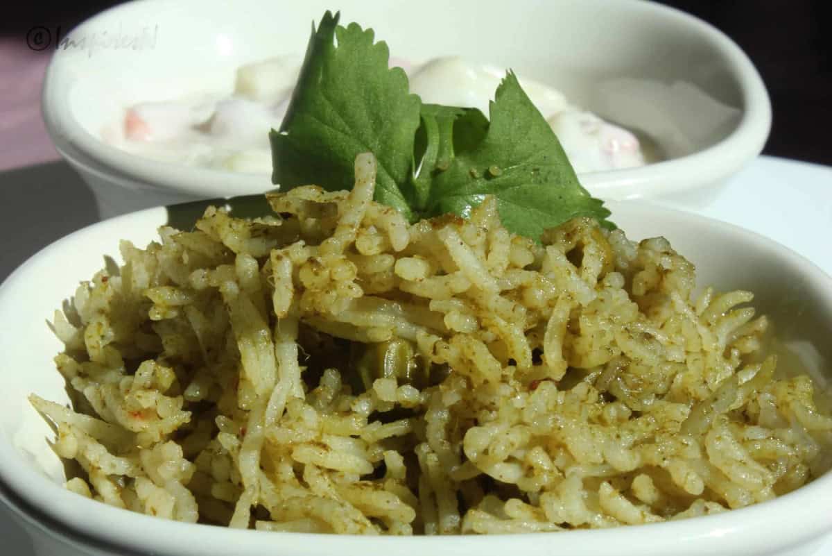 Pudina pulav (Mint Rice) with yogurt salad in white bowls.
