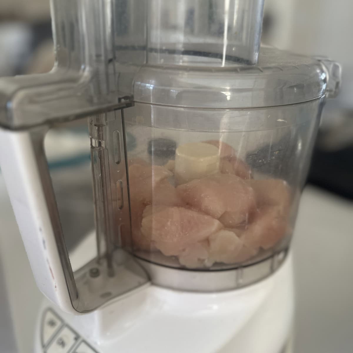 Mincing chicken in a food processor.