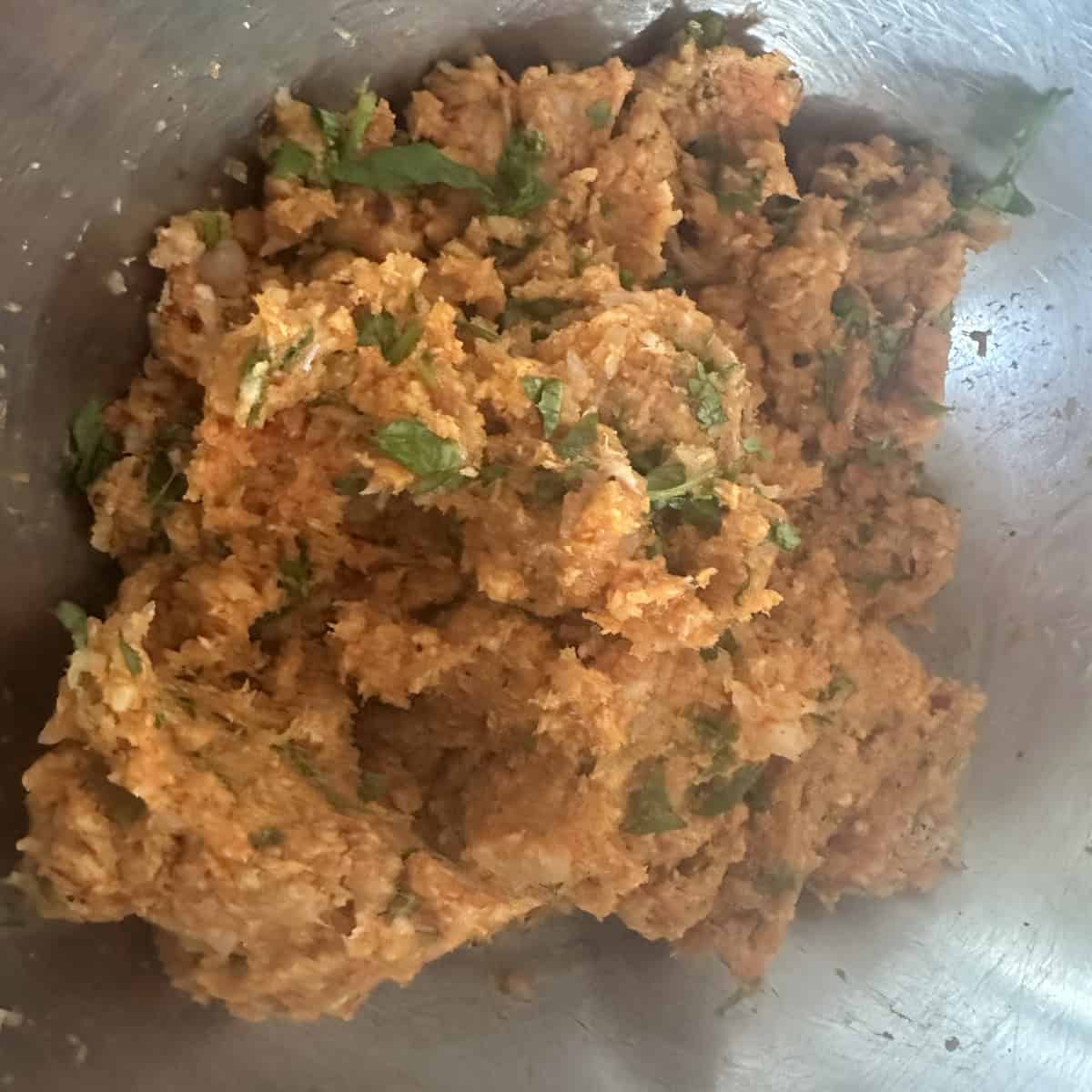 Minced chicken patty base in a steel bowl ready to be shaped.