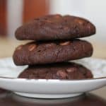 best double chocolate chip cookies stacked on a white plate.