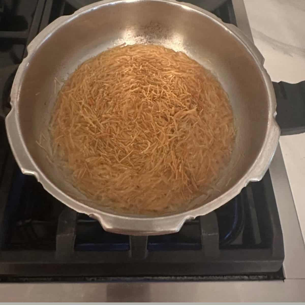 cooking vermicelli in water in a cooker.