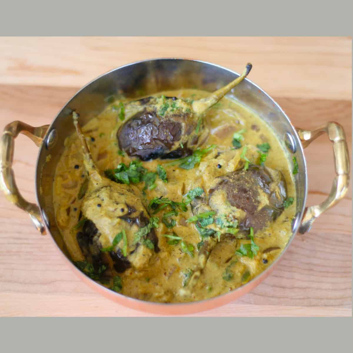 Bagara Baingan made with Bagara baingan recipe served in a copper vessel.