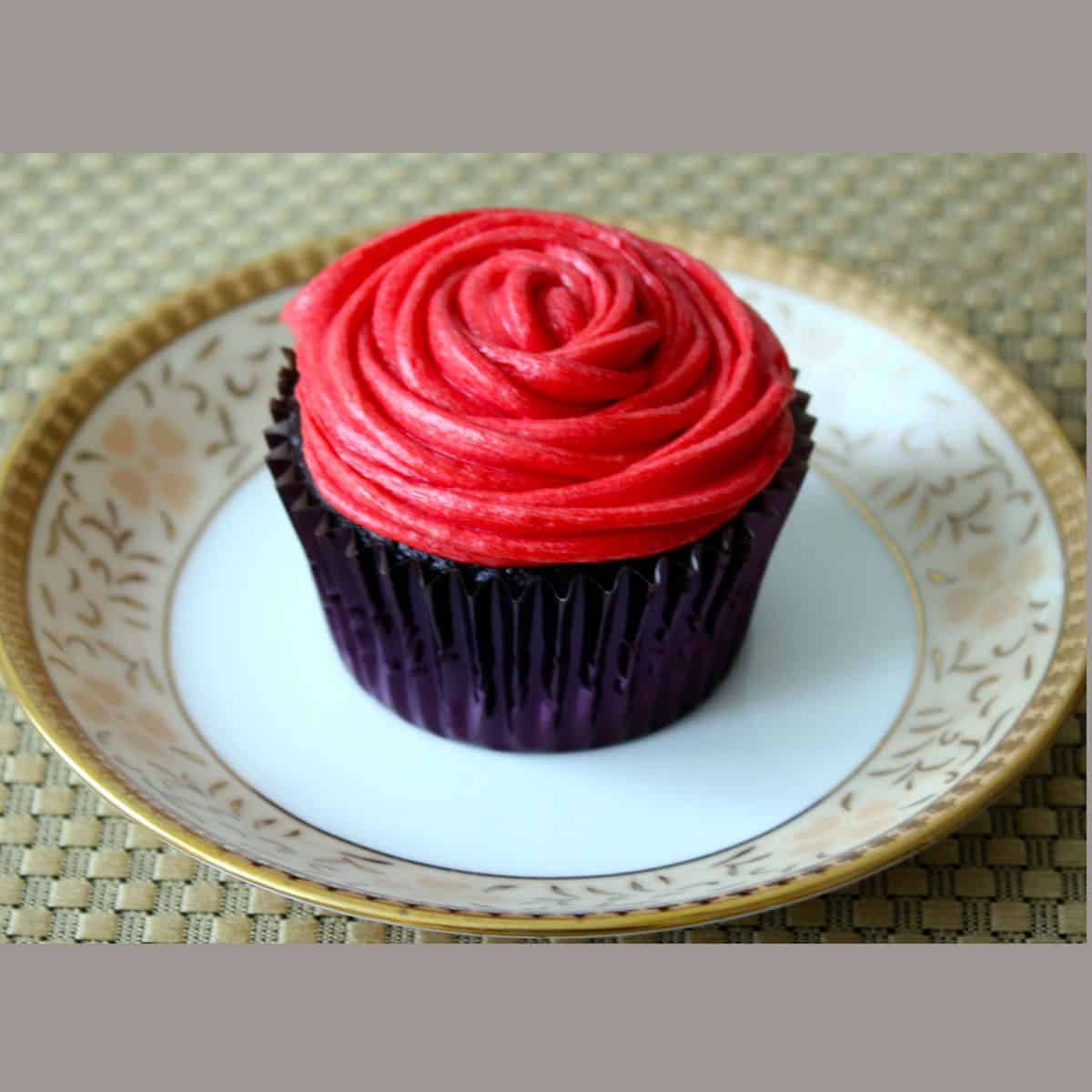 Best Chocolate Cupcake with butter cream frosting in a china dessert plate.