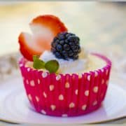 Baked mini cheesecakes with whipped cream and berries.