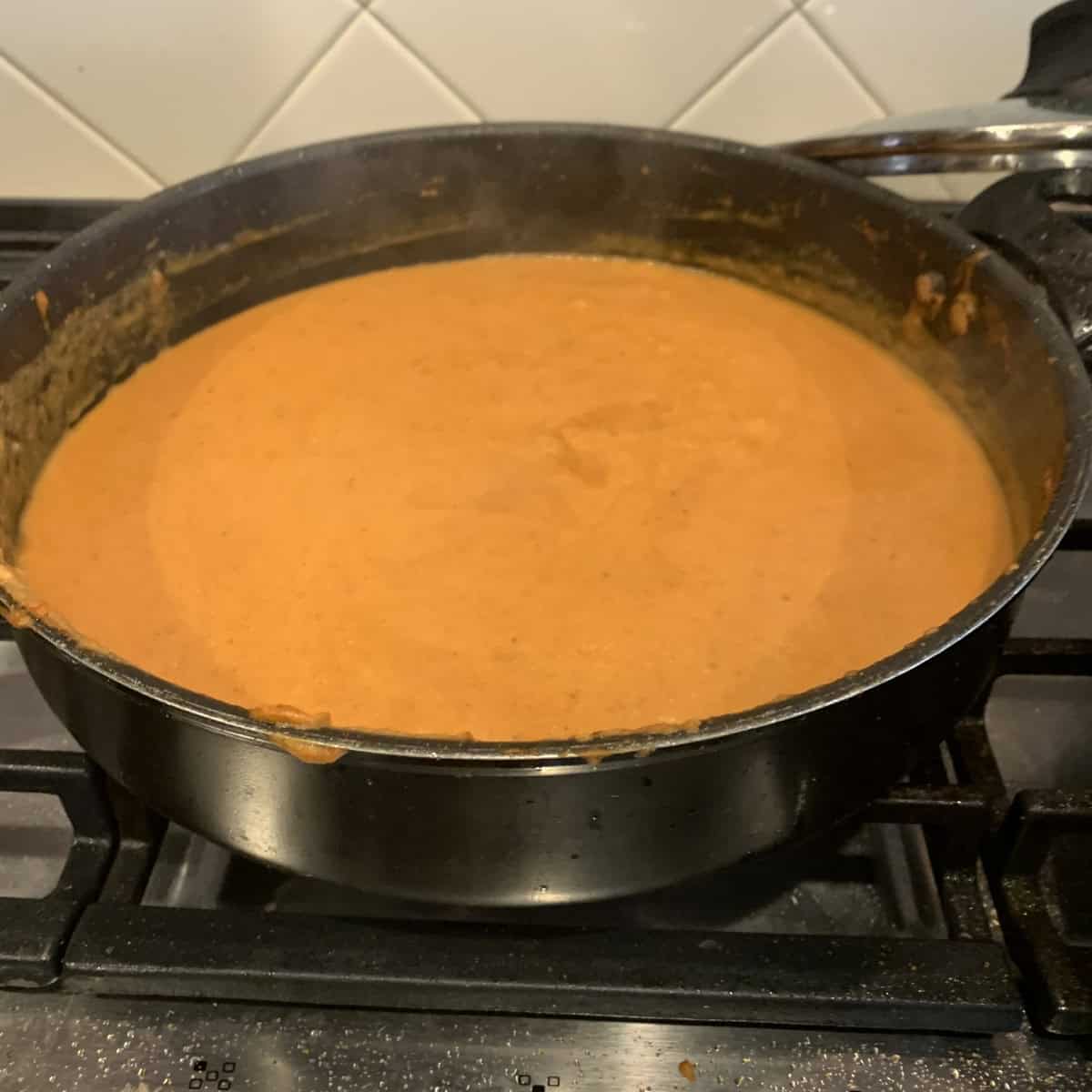 Paneer Tikka Masala gravy cooked in a black pan.