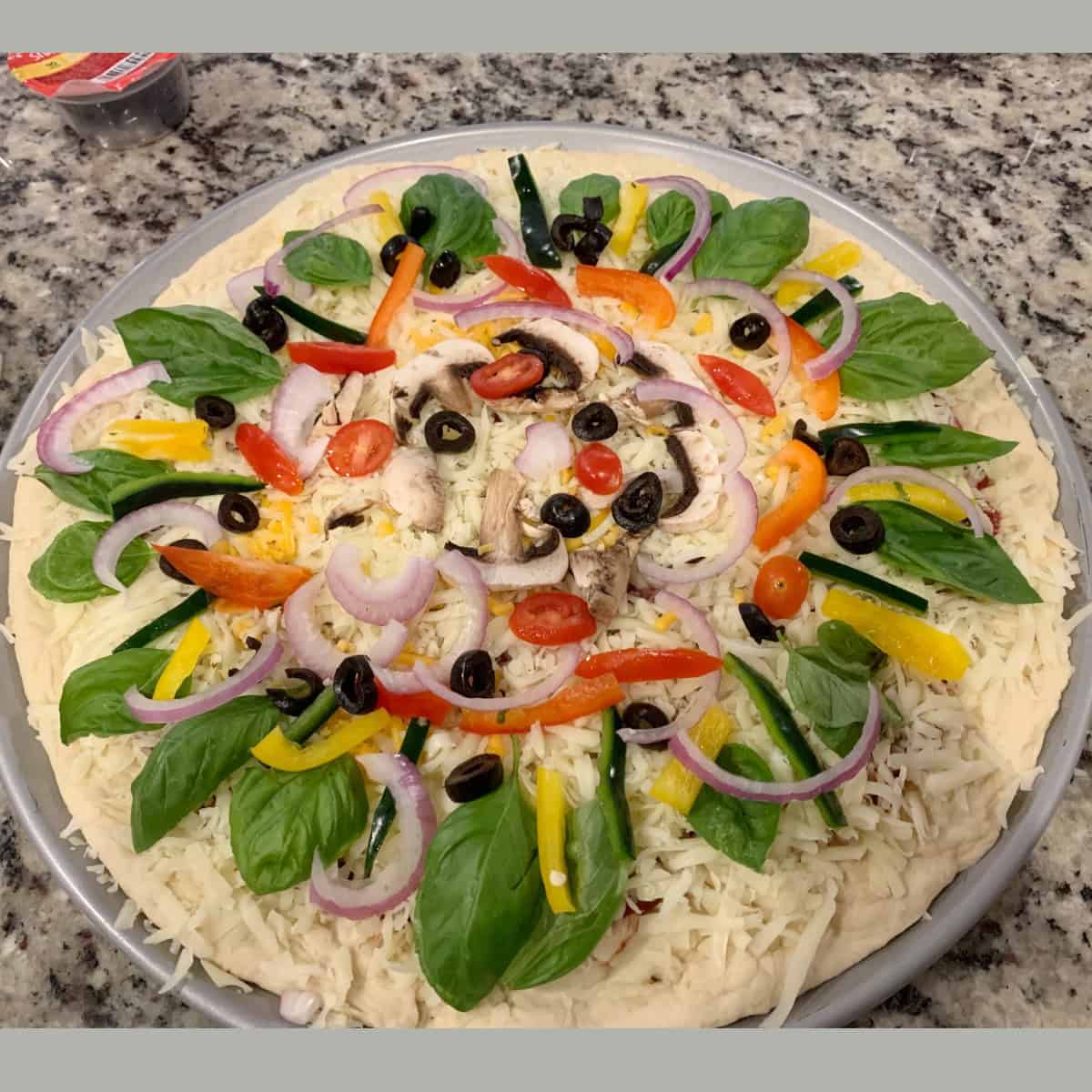 pizza with toppings ready to go into oven.
