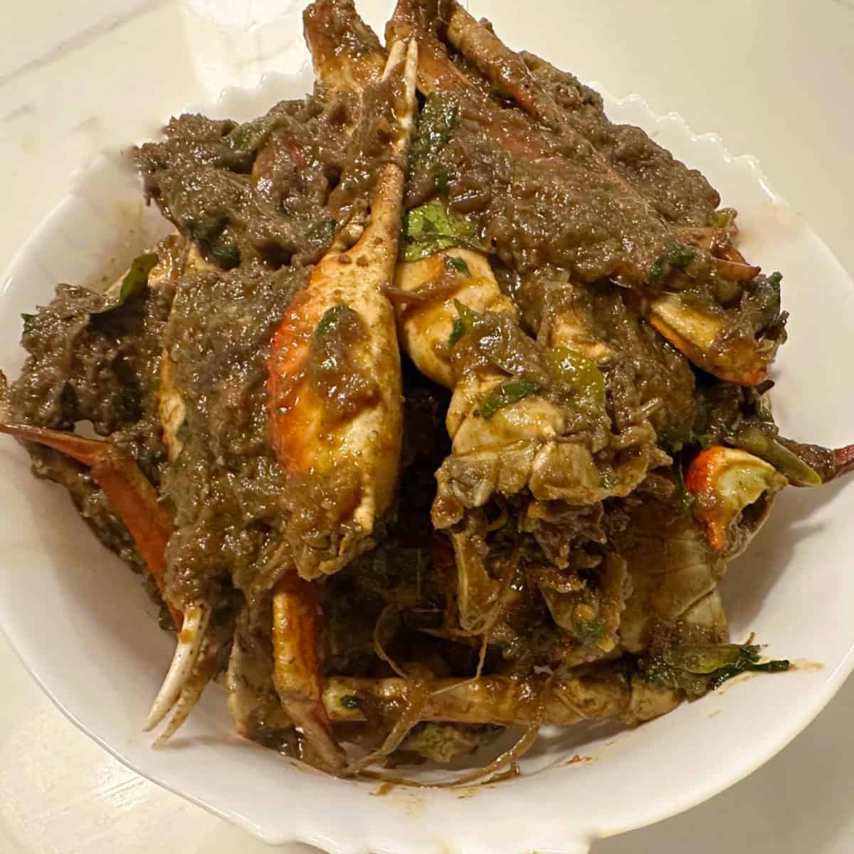 crad curry masala served in a white bowl.