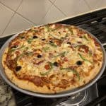vegetarian pizza baked in a pizza pan ready to serve.