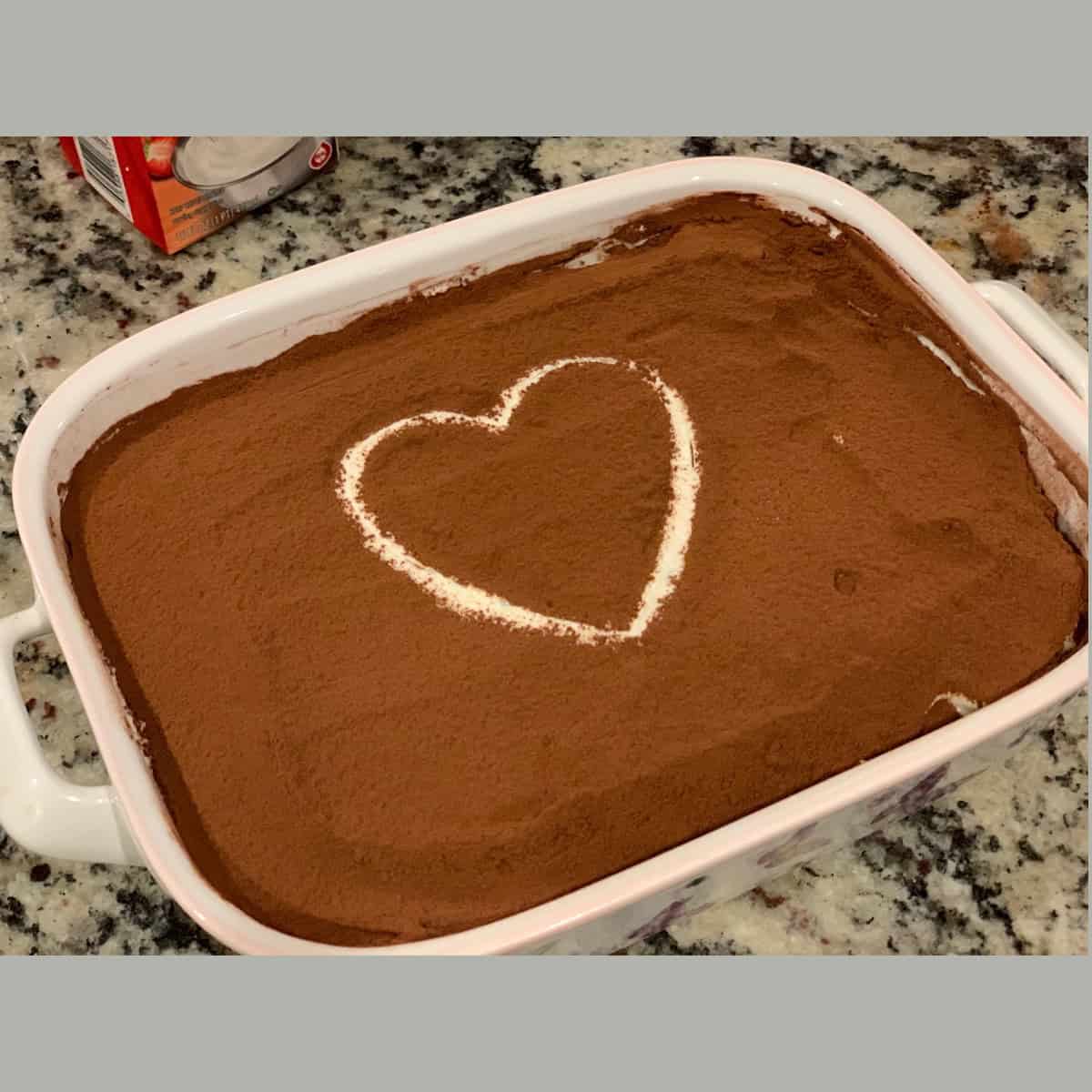 Tiramisu recipe with eggs served in a white dessert casserole.