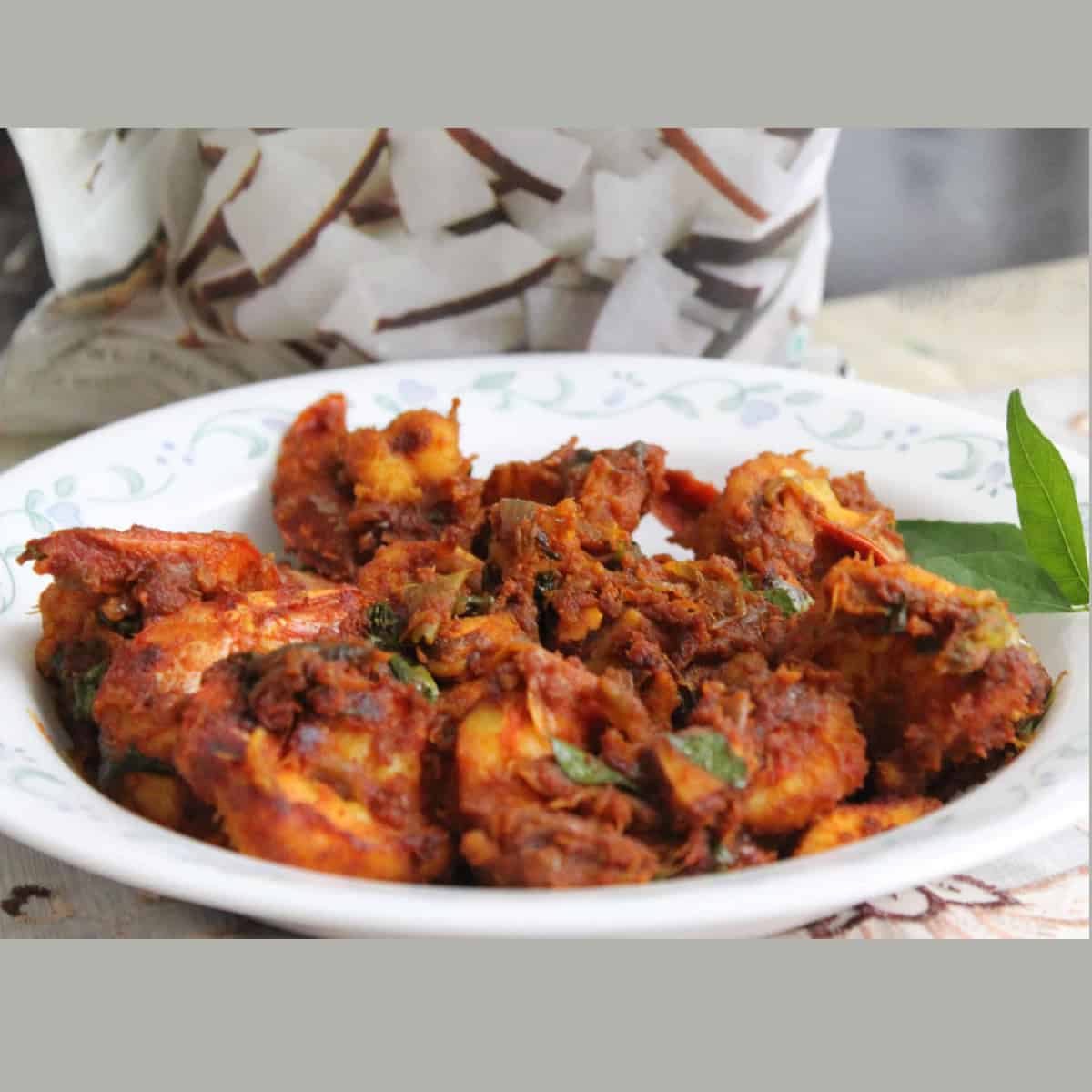 chemmeen roast or Kerala Prawn Roast served in a white plate.