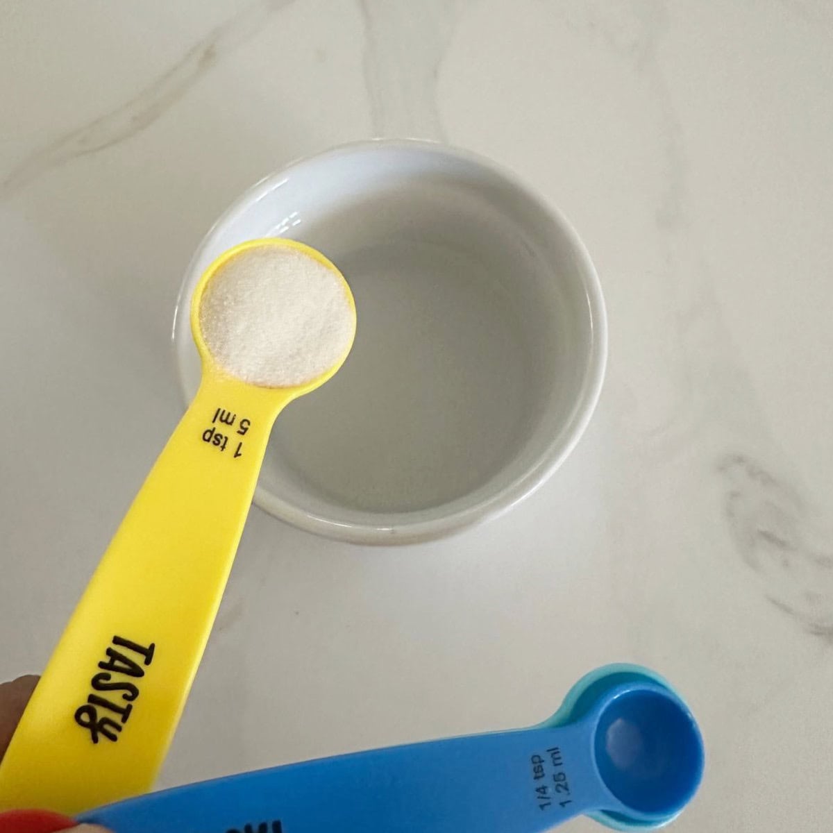 gelatin being added to water.
