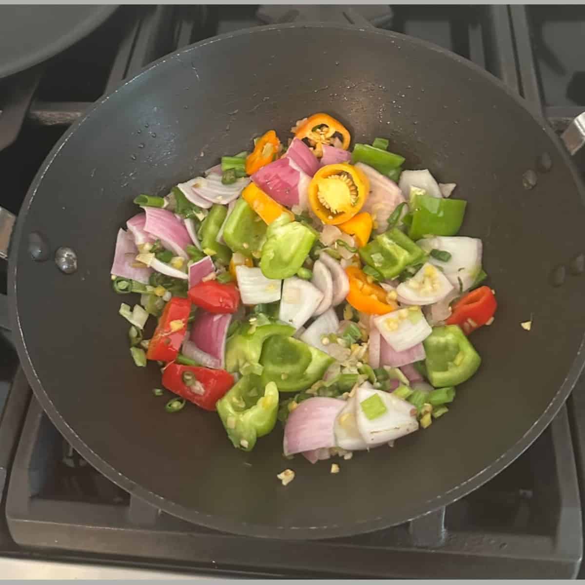 sautee bell peppers and onions in wok.