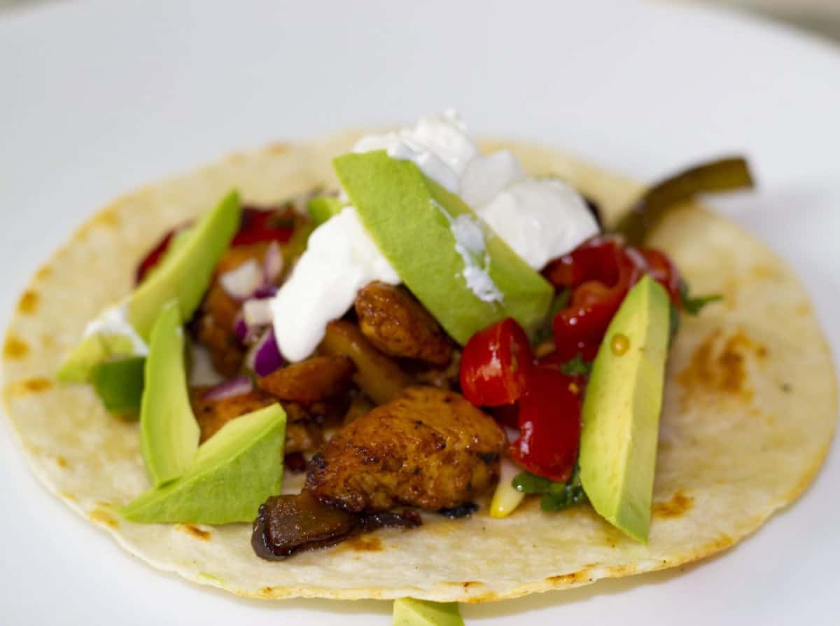 homemade fajitas with chicken, avocado and sourcream.