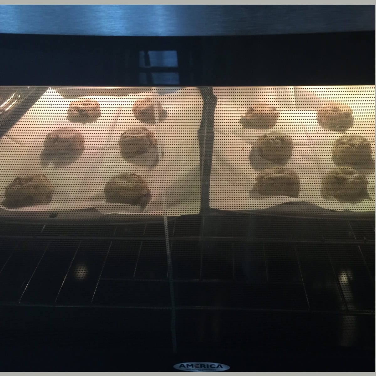 Almond flour chocolate chip cookies baking in an oven.