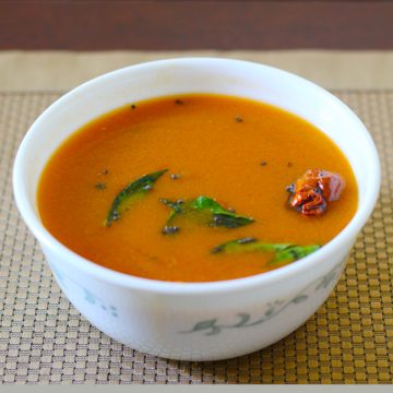 Rasam made with easy rasam recipe served in a white bowl.