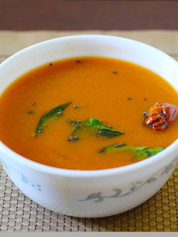 Rasam made with easy rasam recipe served in a white bowl.