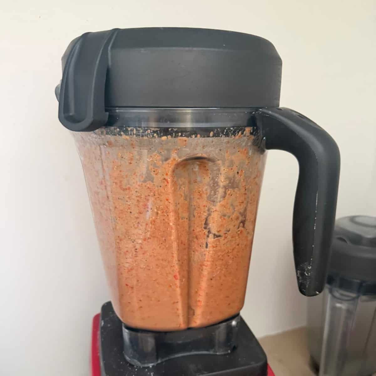 Rasam paste being ground in a mixie.