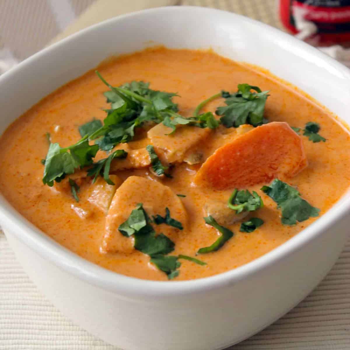 Thai red curry made with Thai red curry chicken recipe served in a white bowl.
