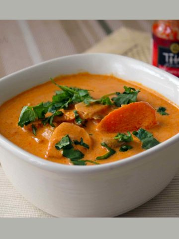 Thai red curry made with Thai red curry chicken recipe served in a white bowl.