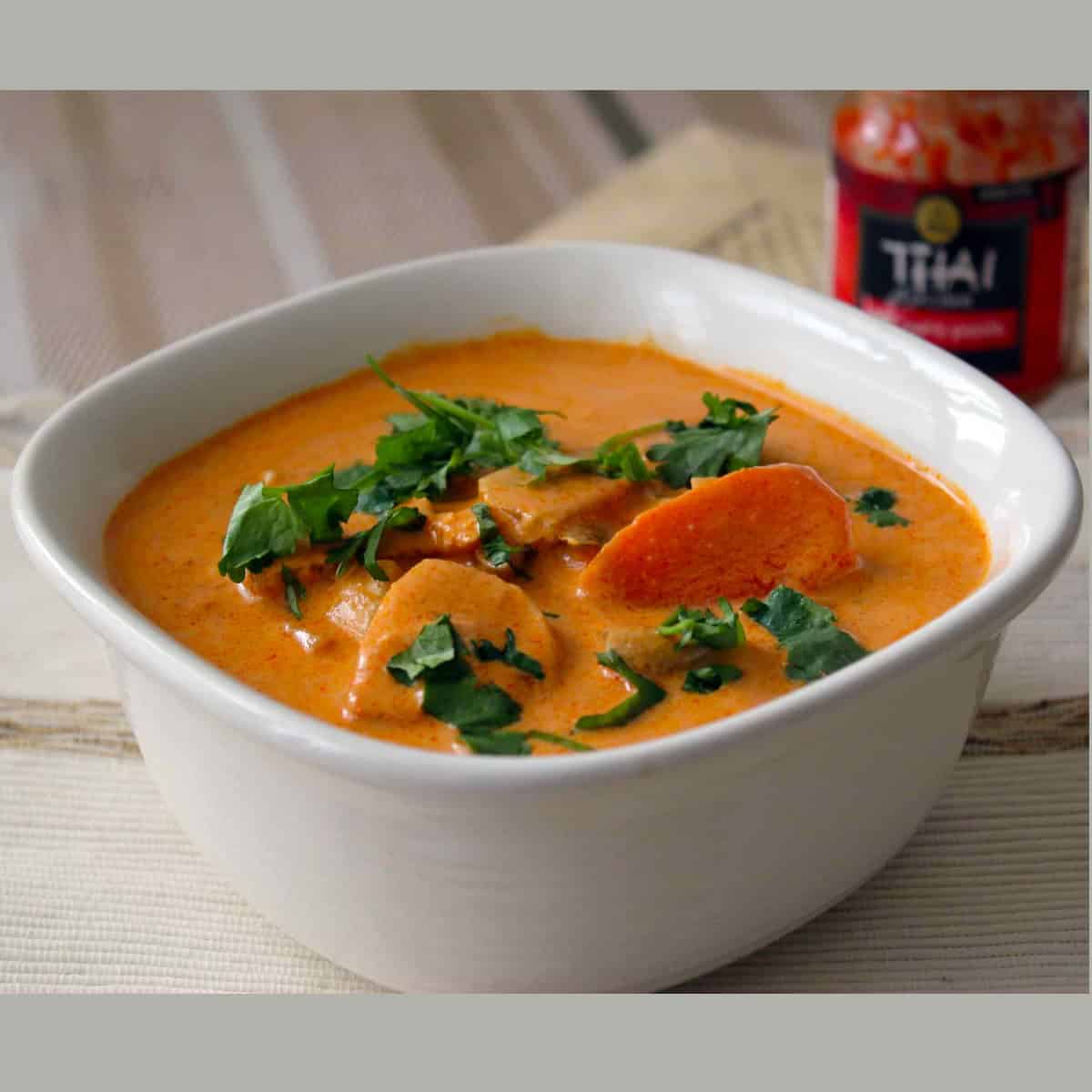 Thai red curry made with Thai red curry chicken recipe served in a white bowl.