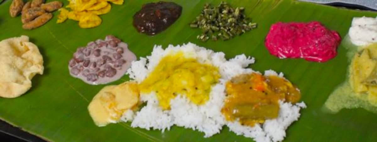 onam sadya dishes served on a banana leaf.