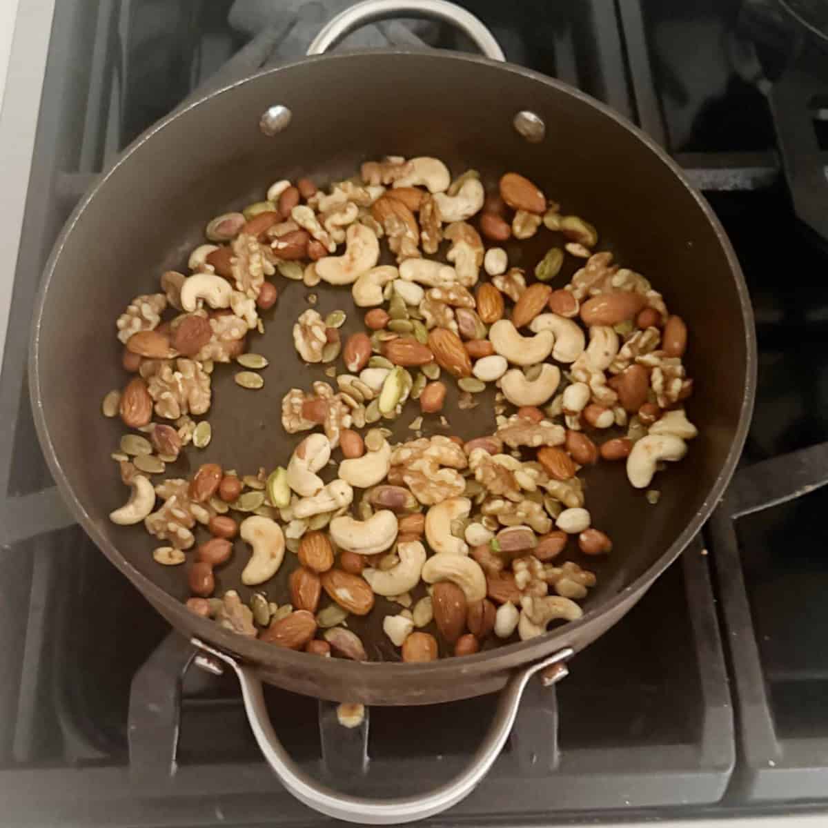 nuts being roasted for protein laddu.