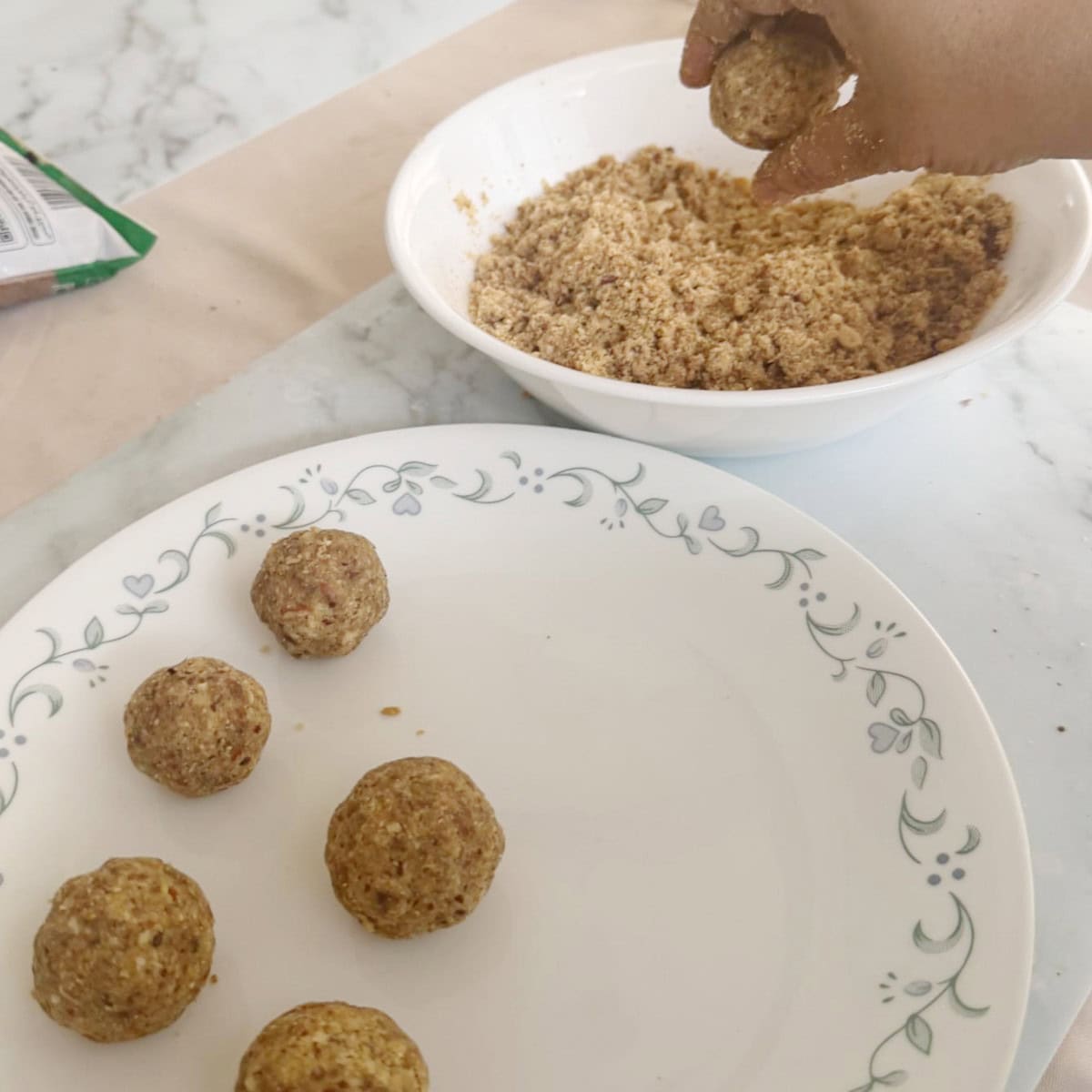 protein laddu being rolled into a round shape.